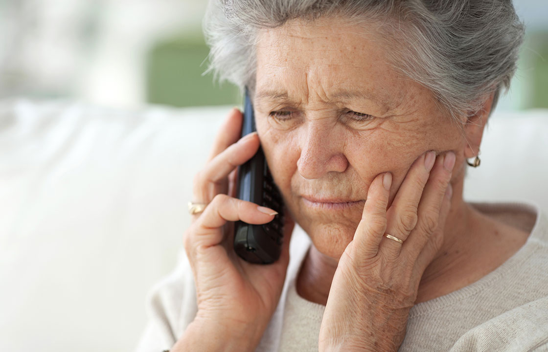 woman on phone with concerned look on her face